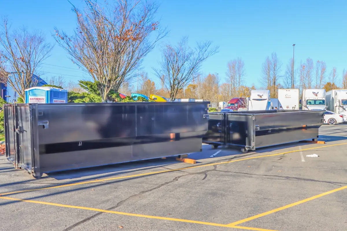 Professional dumpster rental service with roll-off container on residential driveway in Peninsula